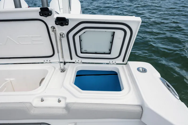  Yacht Photos Pics Open storage compartment on 2024 Solace 32 CS boat, near water.
