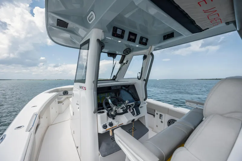 Yacht Photos Pics 2024 Solace 32 CS boat interior with helm, steering wheel, and ocean view.
