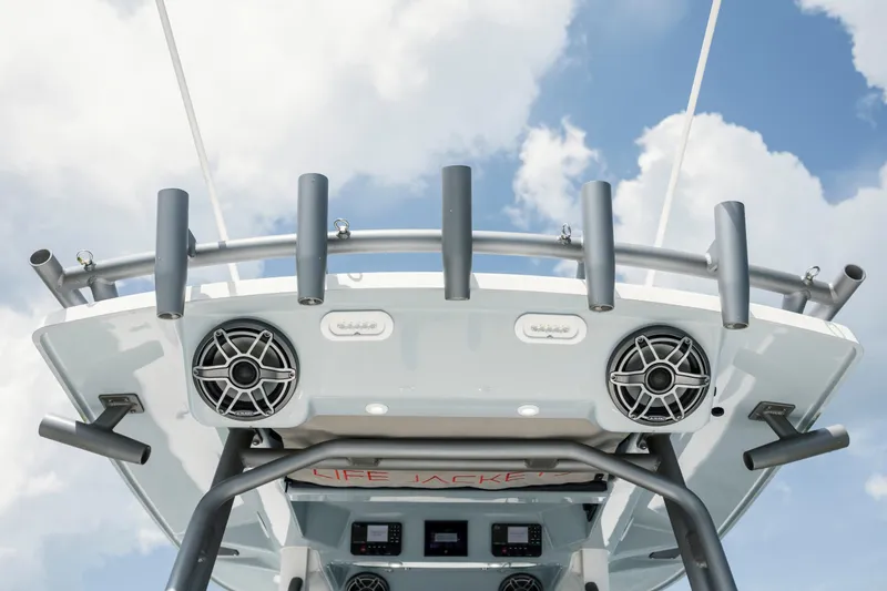  Yacht Photos Pics 2024 Solace 32 CS boat with rod holders and speakers against a cloudy sky.