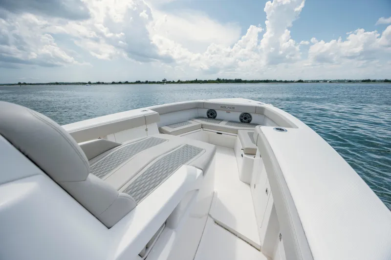  Yacht Photos Pics 2024 Solace 32 CS boat interior with luxurious seating on a calm water backdrop.