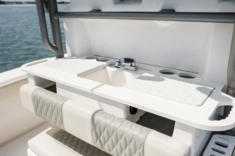  Yacht Photos Pics 2024 Solace 32 CS boat interior with sink, cutting board, and cushioned seating.