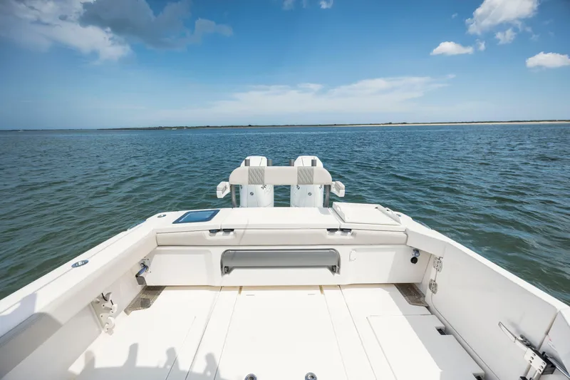  Yacht Photos Pics 2024 Solace 32 CS boat deck overlooking calm ocean waters under blue sky.