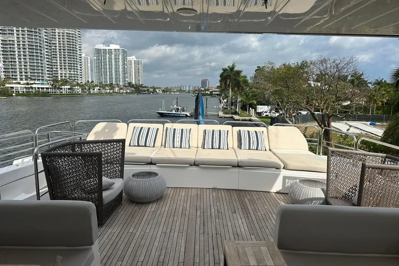 Blue Yacht Photos Pics Luxurious 2011 Azimut 112 yacht deck with seating, overlooking waterfront and cityscape.
