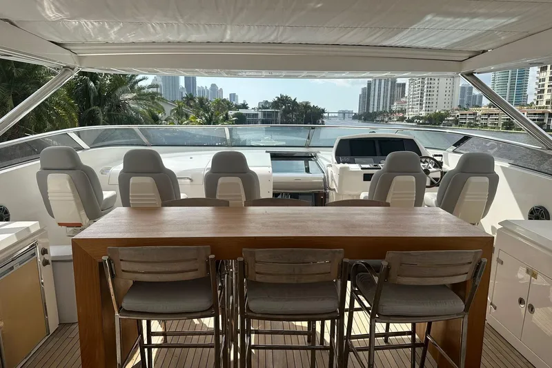 Blue Yacht Photos Pics Luxurious 2011 Azimut 112 yacht deck with seating, overlooking waterfront cityscape.