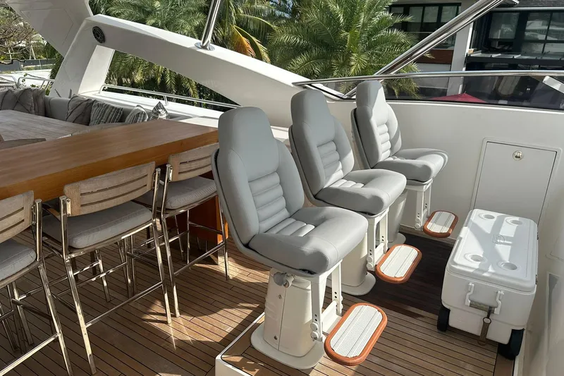 Blue Yacht Photos Pics Luxury seating area on 2011 Azimut 112 yacht with plush chairs and wooden accents.