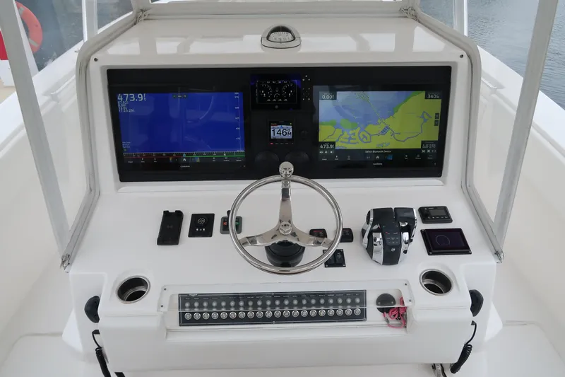 Bad Habit Yacht Photos Pics 2016 Invincible 42 Open Fisherman boat dashboard with dual navigation screens and controls.