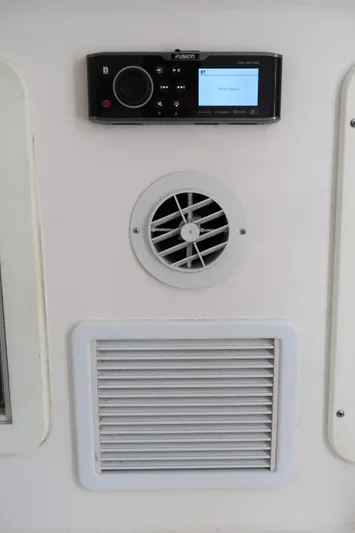 Bad Habit Yacht Photos Pics 2016 Invincible 42 Open Fisherman control panel with air vents and audio system.