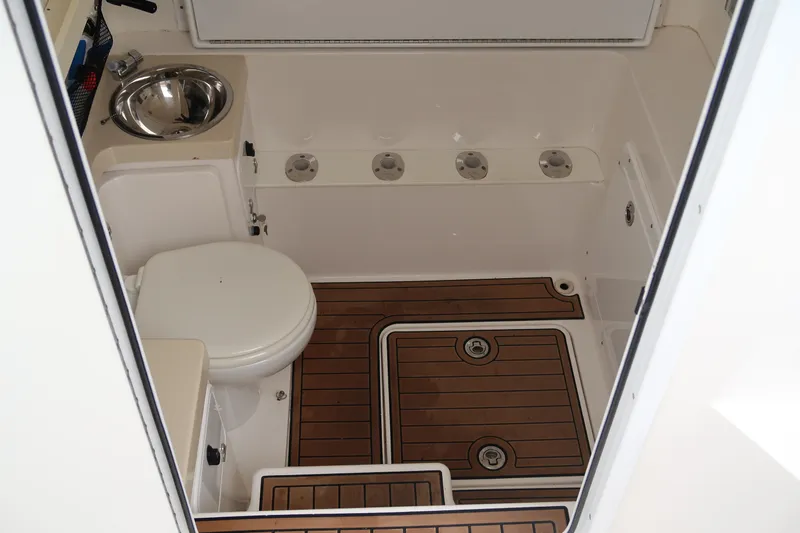 Bad Habit Yacht Photos Pics 2016 Invincible 42 Open Fisherman boat bathroom with wooden flooring and stainless steel sink.