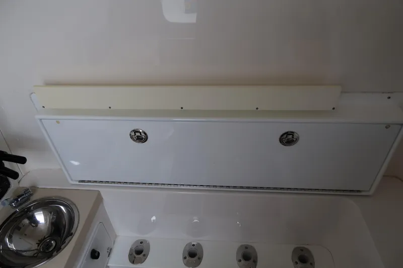 Bad Habit Yacht Photos Pics 2016 Invincible 42 Open Fisherman boat interior with sink and storage compartments.