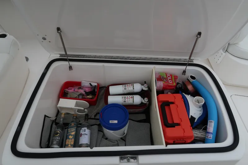 Bad Habit Yacht Photos Pics Storage compartment of a 2016 Invincible 42 Open Fisherman boat with various supplies.