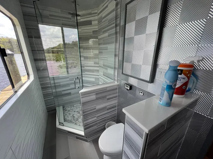 Slippery When Wet Yacht Photos Pics Modern bathroom on 1989 Sumerset Houseboat with glass shower and lake view.