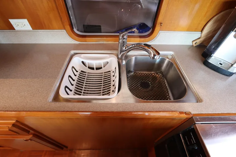 Sea Cow Yacht Photos Pics Kitchen sink area on 2005 DeFever 49 Cockpit Motor Yacht with dish rack and faucet.