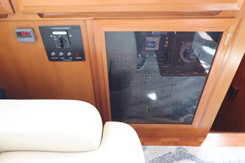 Sea Cow Yacht Photos Pics Control panel of a 2005 DeFever 49 Cockpit Motor Yacht with wooden finish.