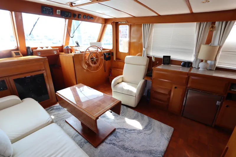 Sea Cow Yacht Photos Pics Luxurious interior of 2005 DeFever 49 Cockpit Motor Yacht with elegant wood finish.