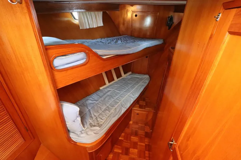 Sea Cow Yacht Photos Pics Bunk beds in 2005 DeFever 49 Cockpit Motor Yacht cabin with wooden interior.