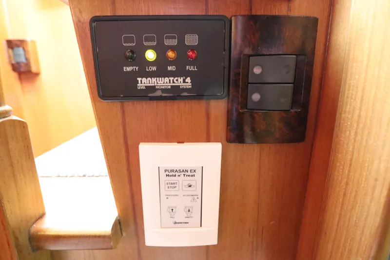 Sea Cow Yacht Photos Pics Control panel on 2005 DeFever 49 Cockpit Motor Yacht, featuring TankWatch 4 and Purasan EX systems.