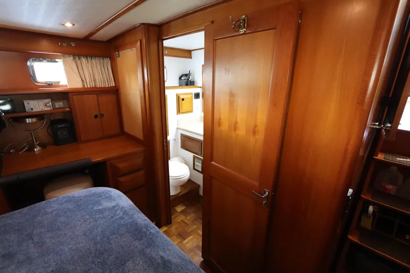 Sea Cow Yacht Photos Pics Interior of 2005 DeFever 49 Cockpit Motor Yacht with wooden cabinetry and cozy furnishings.