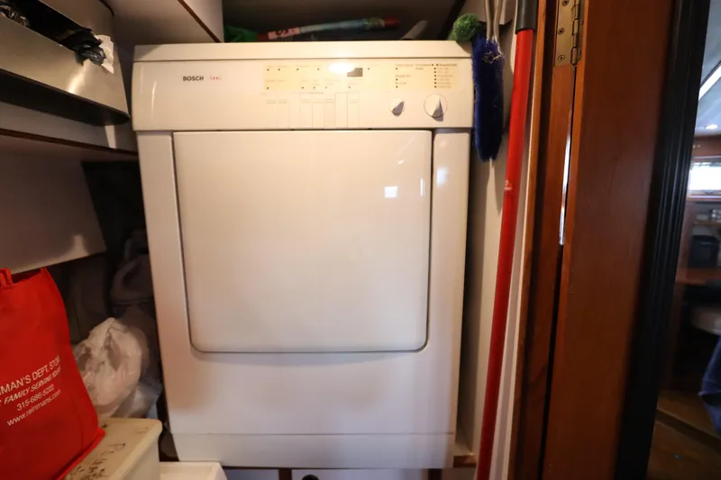 Sea Cow Yacht Photos Pics Bosch dryer inside 2005 DeFever 49 Cockpit Motor Yacht laundry area.