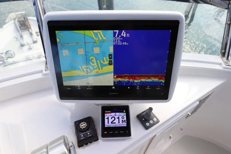 Sea Cow Yacht Photos Pics Navigation system on 2005 DeFever 49 Cockpit Motor Yacht displaying depth and map.