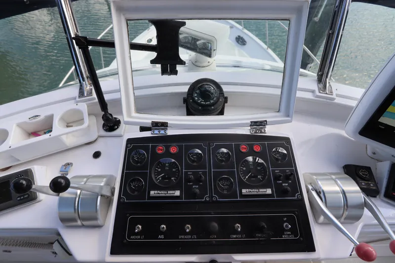 Sea Cow Yacht Photos Pics Control panel of a 2005 DeFever 49 Cockpit Motor Yacht with navigational instruments.