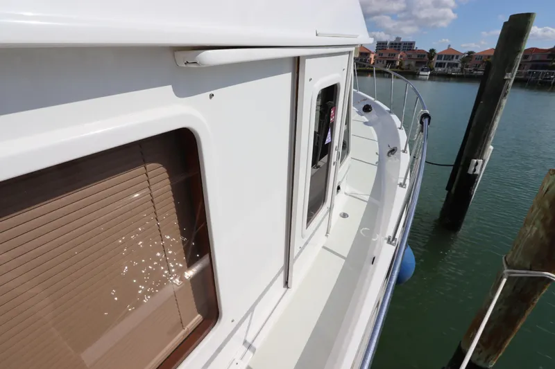 Sea Cow Yacht Photos Pics 2005 DeFever 49 Cockpit Motor Yacht docked, side view with water reflections.