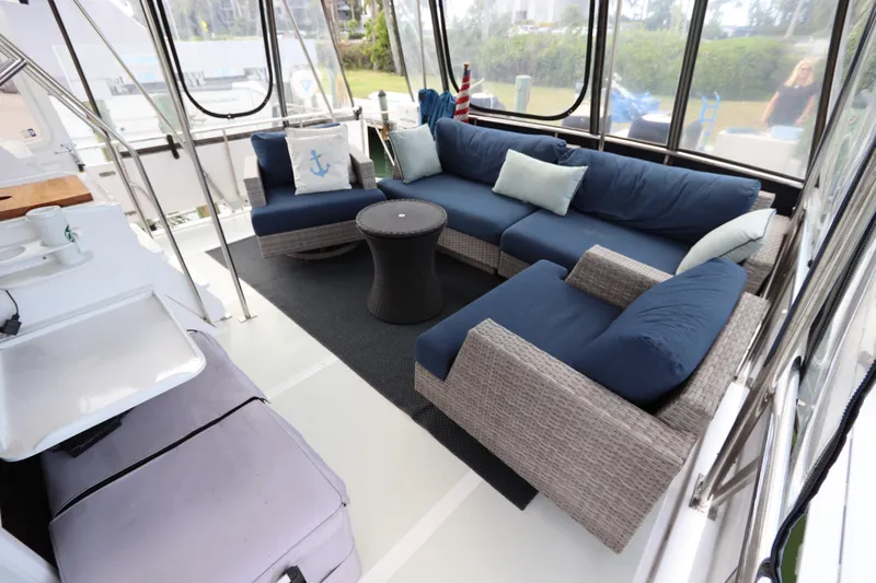 Sea Cow Yacht Photos Pics Luxurious 2005 DeFever 49 Cockpit Motor Yacht with elegant outdoor seating area.