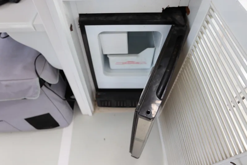 Sea Cow Yacht Photos Pics Open mini fridge on 2005 DeFever 49 Cockpit Motor Yacht, interior view.