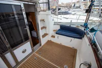 Nimbus 380 Commander 2005 yacht deck with wooden flooring and cushioned seating.