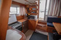 Interior of 2005 Nimbus 380 Commander boat with kitchen and seating area.