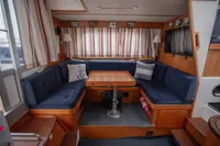 Cozy interior of 2005 Nimbus 380 Commander with blue seating and wooden accents.