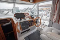 Cockpit of 2005 Nimbus 380 Commander yacht with navigation equipment and marina view.