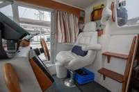 Interior of 2005 Nimbus 380 Commander boat with captain's chair and control panel.