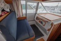 Interior of 2005 Nimbus 380 Commander boat with blue seating and wooden accents.