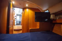 Interior of 2005 Nimbus 380 Commander yacht with wood paneling and mounted TV.