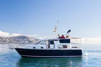 Nimbus 380 Commander 2005 yacht cruising on calm waters under a clear blue sky.
