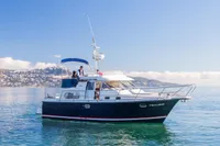 Nimbus 380 Commander 2005 yacht cruising on calm waters under clear blue skies.