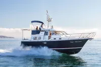 Nimbus 380 Commander 2005 cruising on calm waters with passengers on deck.