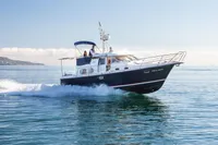 Nimbus 380 Commander 2005 cruising on calm blue waters under clear skies.