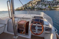 Cockpit view of 2005 Nimbus 380 Commander yacht with scenic coastal backdrop.