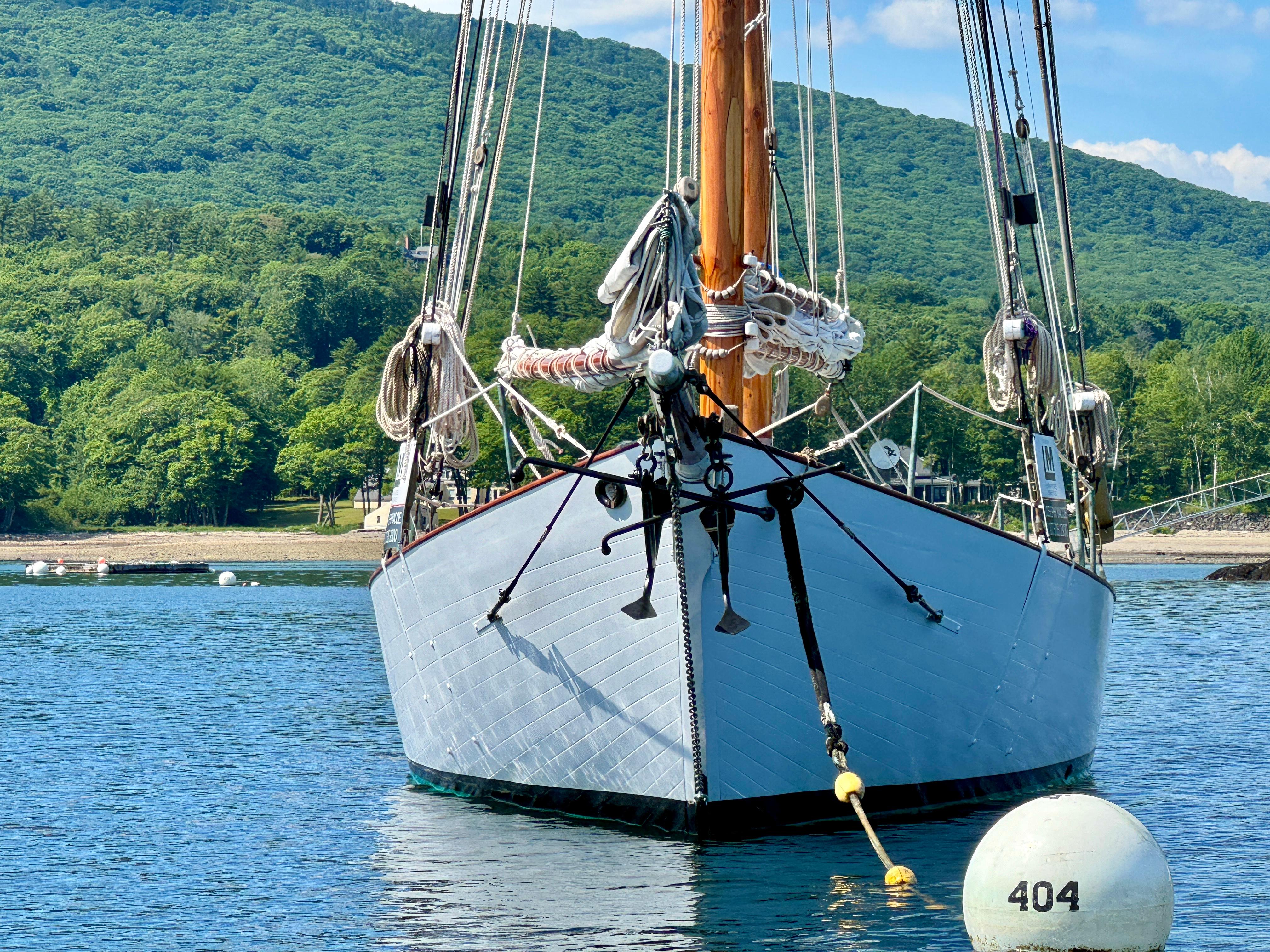 Front view of 1996 Custom John Alden Malabar II sailboat on calm water.