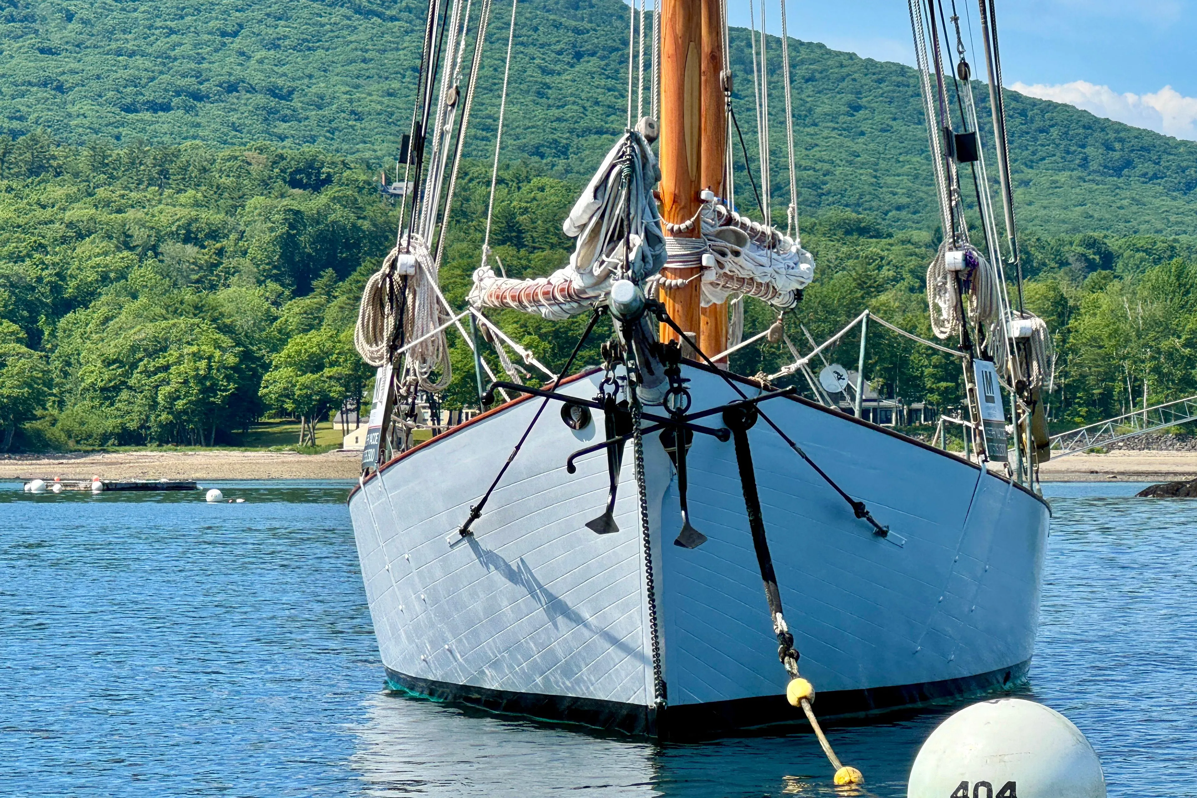 Front view of 1996 Custom John Alden Malabar II sailboat on calm water.