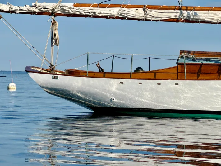 Alyria Yacht Photos Pics Sailboat "John Alden Malabar II" from 1996 on calm water, showcasing classic wooden design.