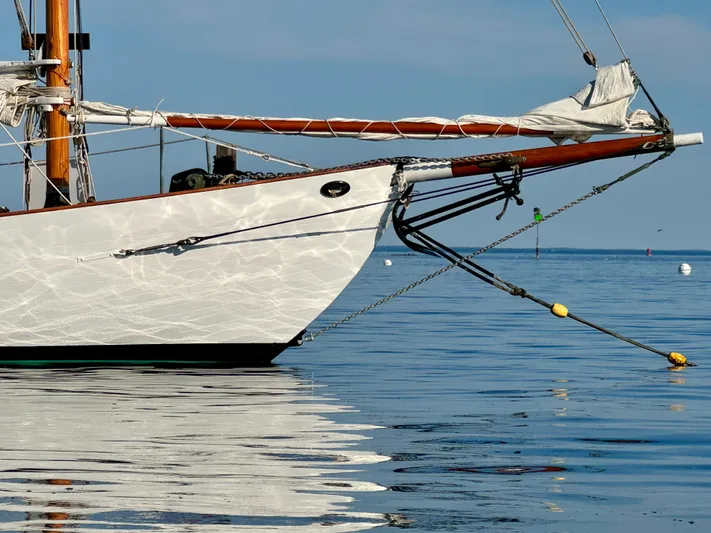 Alyria Yacht Photos Pics Sailboat bow on calm water, Custom John Alden Malabar II, 1996 model.
