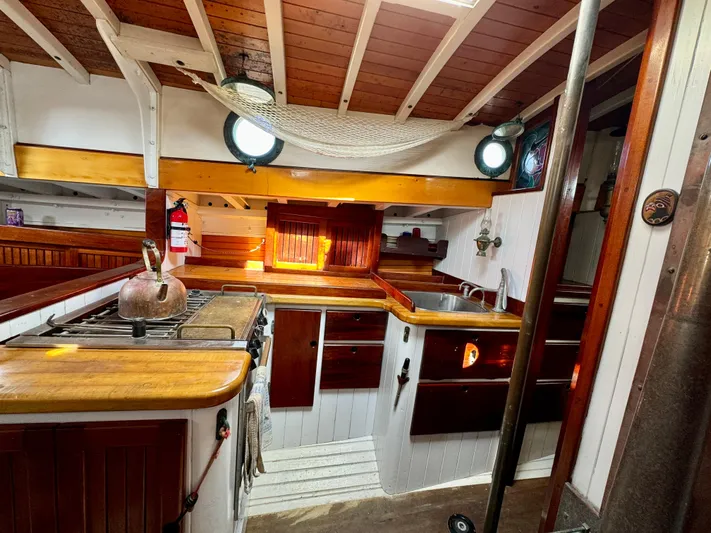 Alyria Yacht Photos Pics Cozy wooden interior of 1996 Custom John Alden Malabar II yacht kitchen.