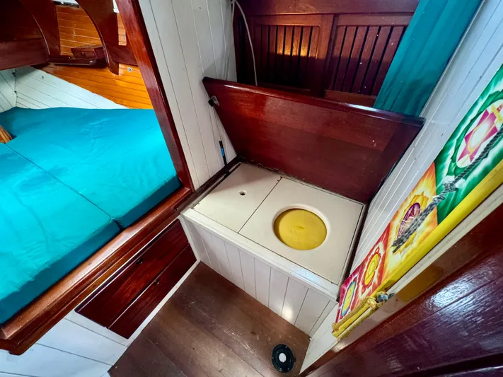 Alyria Yacht Photos Pics Interior of 1996 Custom John Alden Malabar II yacht with wooden cabinetry and blue bedding.