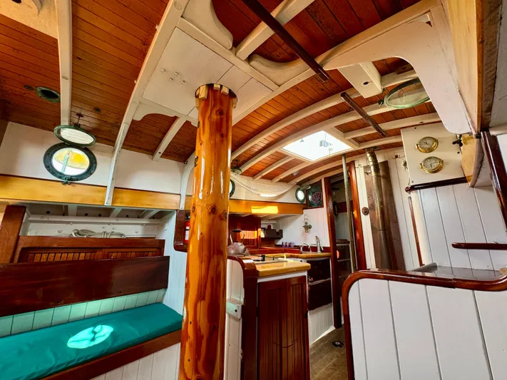 Alyria Yacht Photos Pics Interior of 1996 Custom John Alden Malabar II sailboat with wooden finishes and nautical decor.