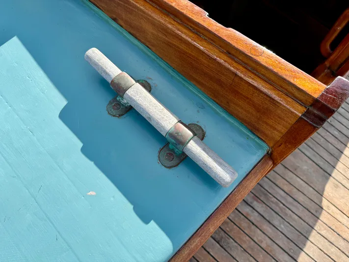 Alyria Yacht Photos Pics Wooden deck detail of 1996 Custom John Alden Malabar II sailboat with metal hinge.