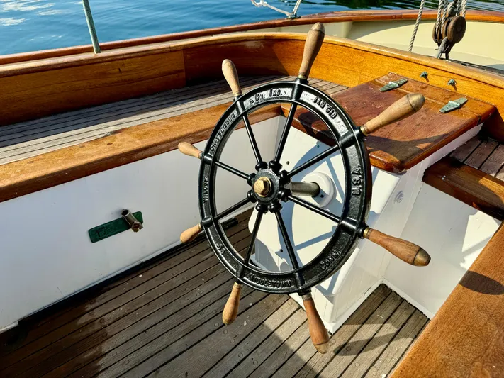 Alyria Yacht Photos Pics Wooden ship wheel on a 1996 Custom John Alden Malabar II sailboat deck.