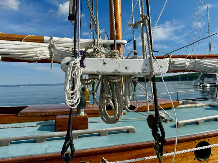 Alyria Yacht Photos Pics Sailboat rigging on a 1996 Custom John Alden Malabar II, with clear blue sky and calm water.