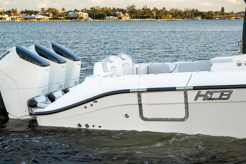  Yacht Photos Pics 2024 HCB 42 Lujo boat with triple engines on a serene water backdrop.